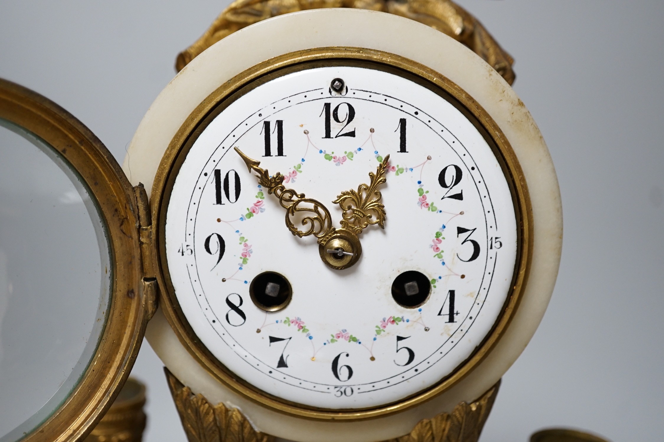 A 19th century alabaster clock garniture, French movement count-wheel striking on a bell, clock 34cm